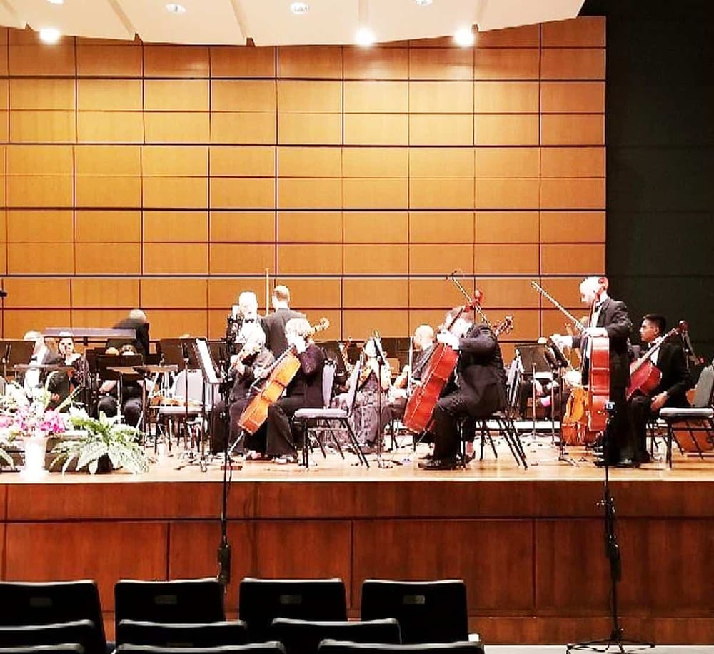 Elegant orchestra performing on stage at QuestForDirections event venue.