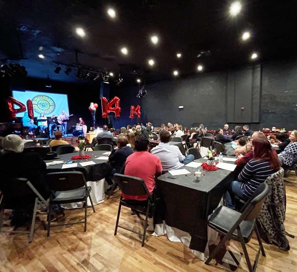 1. Diverse audience enjoying live music performance at a celebration event.