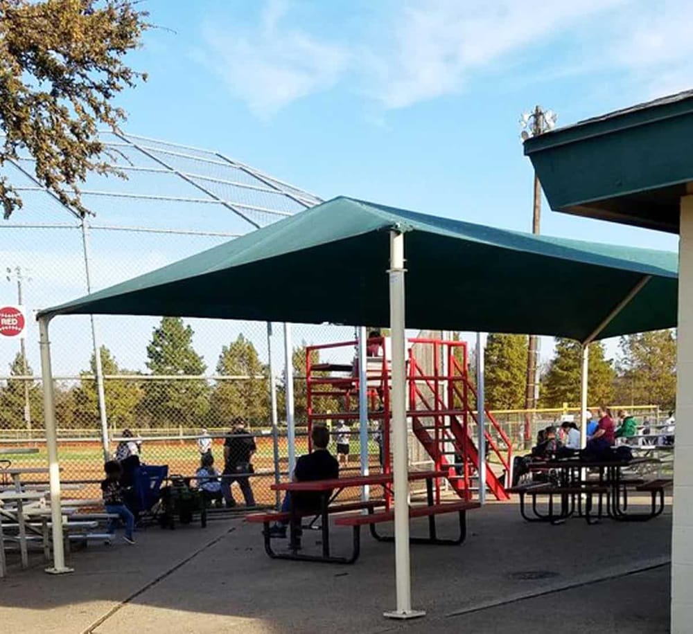 Children's baseball field with seating area and shade canopy, community sports venue, South California.