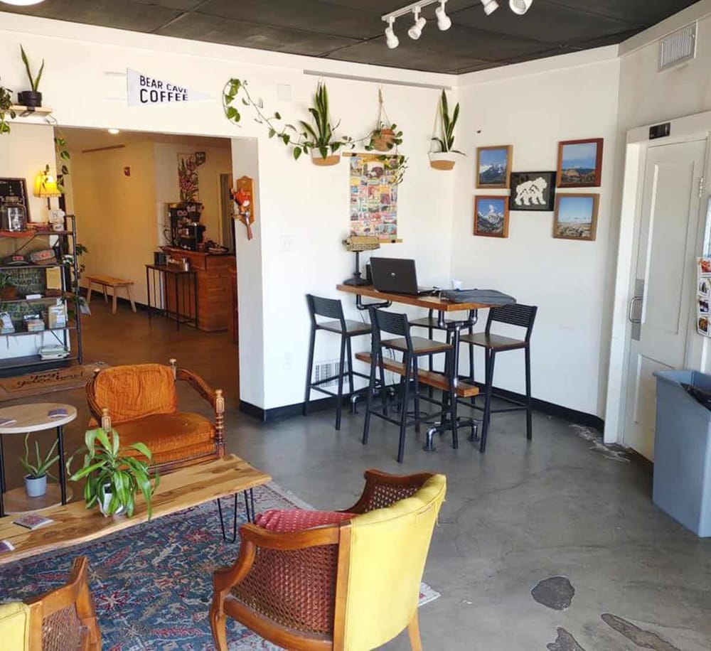 Cozy interior of QuestForDirections with seating area, plants, and artwork, perfect for planning outdoor adventures.