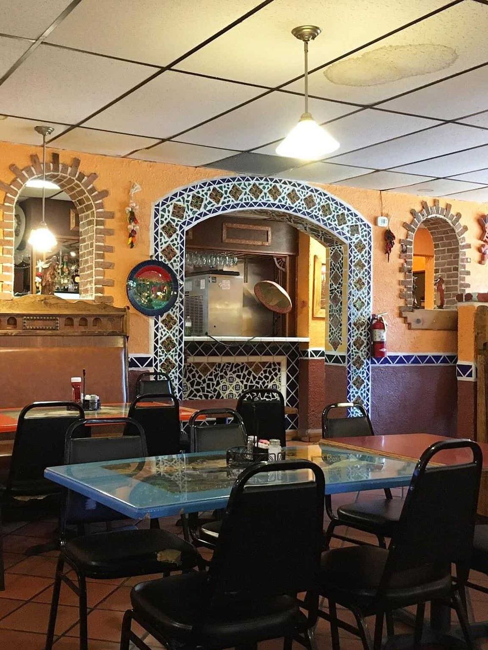 Colorful Mexican restaurant interior with vibrant tile accents and dining tables, perfect for authentic Mexican cuisine.