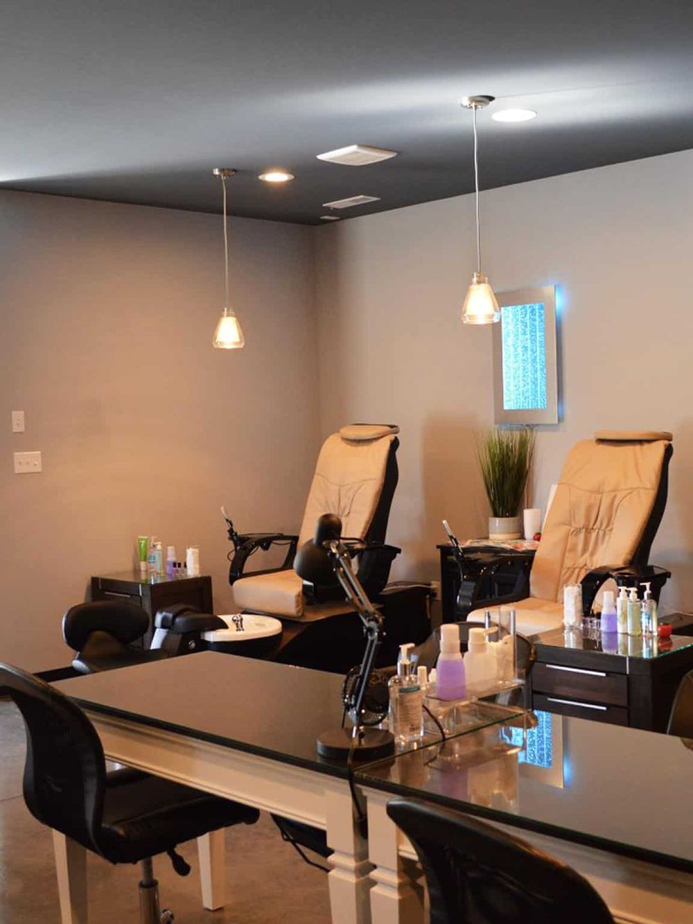 Relaxing nail salon with pedicure chairs and manicure stations for pampering experiences.