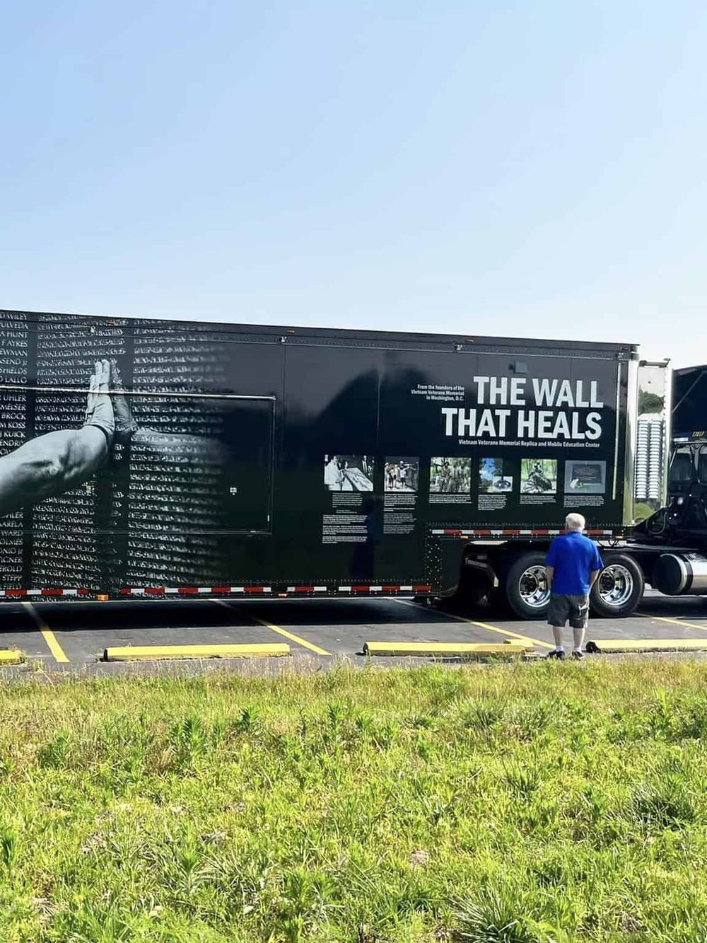 Black truck with "The Wall That Heals" exhibit promoting Vietnam Veterans Memorial and education center.