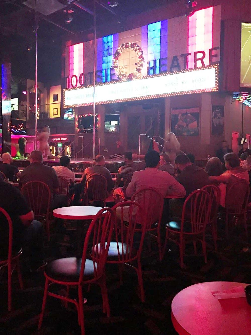 Spicy ladyboy show at the Queer Quarters Theater in Bangkok, Thailand, with audience watching a lively performance.