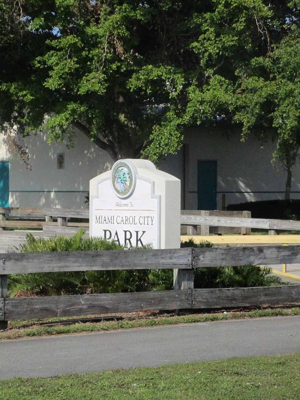 Miami Carol City Park entrance sign with greenery and trees in the background.