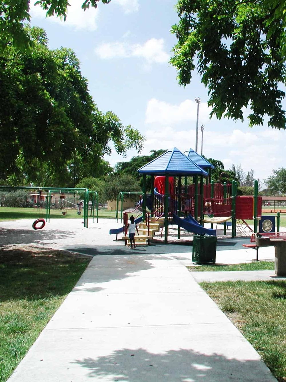 Bright children’s playground at QuestForDirections park, featuring colorful slides and swings.