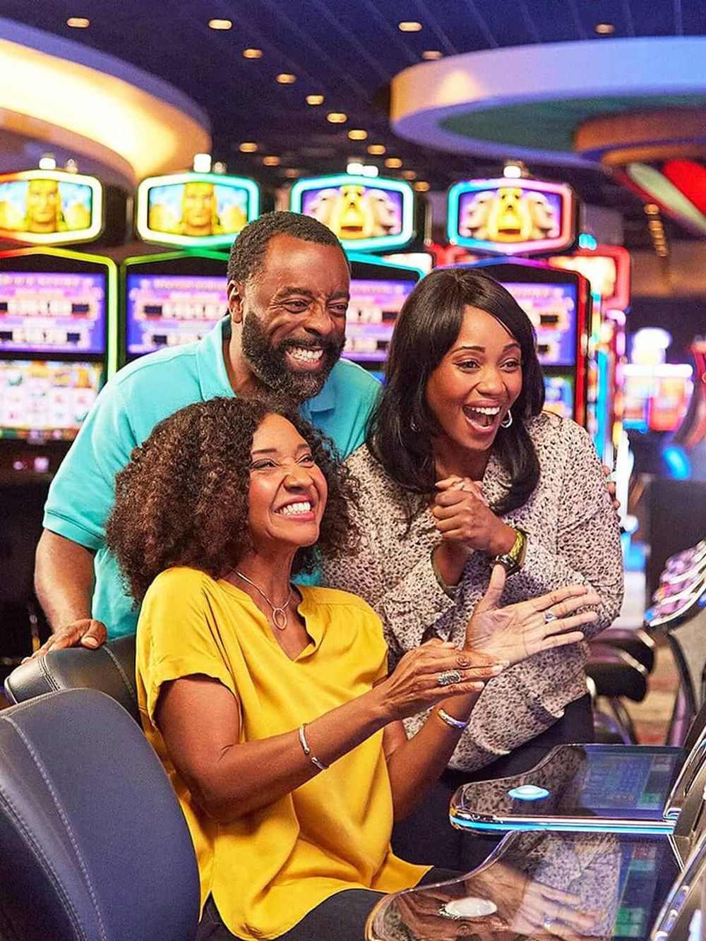 Exciting group playing slot machines at a casino, enjoying a fun night out and winning.
