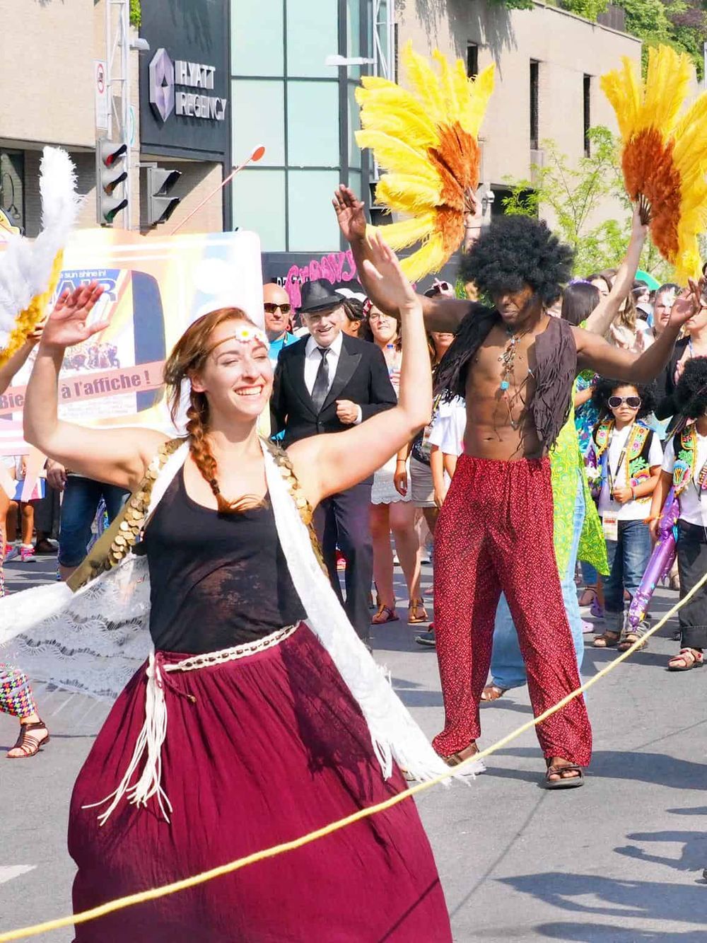 Vibrant street parade with dancers in colorful costumes celebrating diversity and culture.