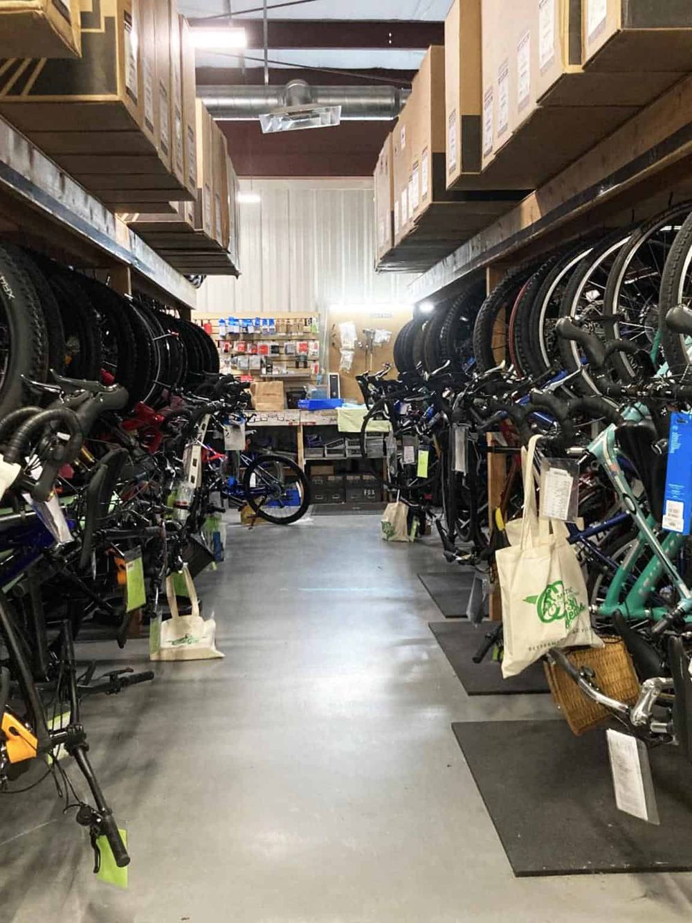 Compact indoor bike shop with bicycles and accessories on display for sale.