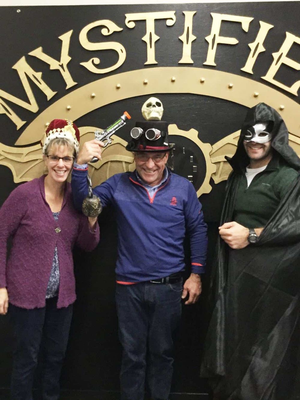 Mystery Escape Room Participants Wearing Costumes and Masks at QuestForDirections.