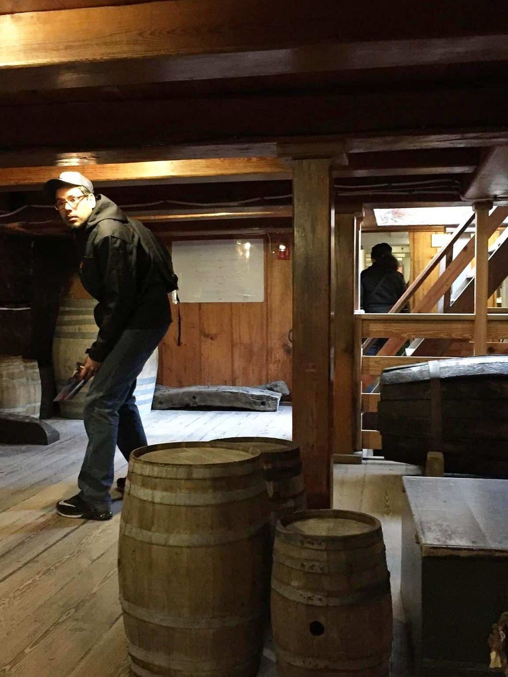 Cozy rustic wine cellar with wooden barrels and staff, perfect for wine tasting and enjoying wine culture.