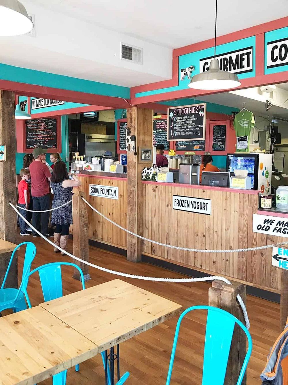 Vegan ice cream shop interior with colorful decor, wooden counters, and smoothie menu, perfect for healthy dessert options.