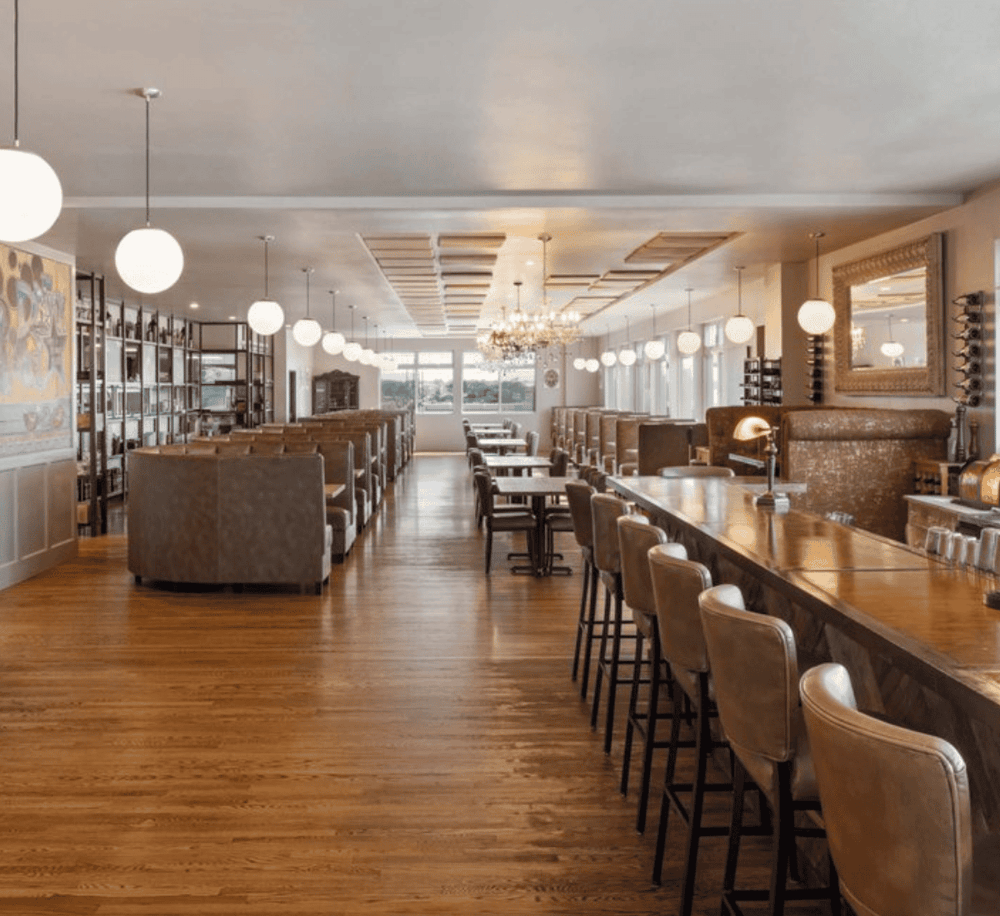 Cozy restaurant interior with elegant décor, warm lighting, and inviting seating, perfect for dining and social gatherings.