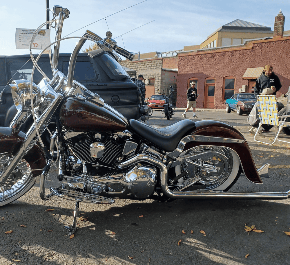 Vivid motorcycle parked outdoors at a classic car and bike meetup event.