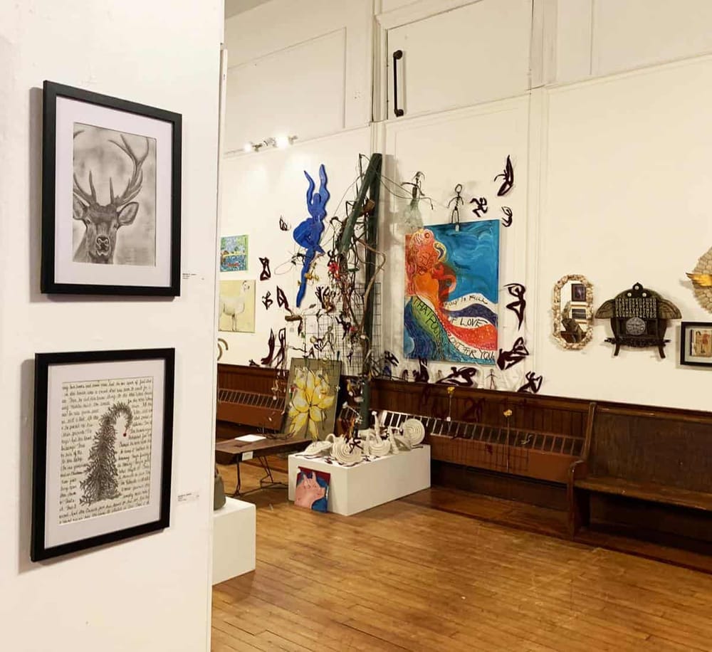 Colorful art gallery exhibit showcasing contemporary paintings and sculptures at QuestForDirections.