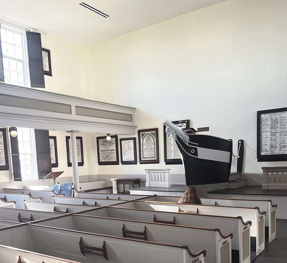 Empty church pews and hymn boards in a historic worship space, Christian church interior, peaceful and serene atmosphere.