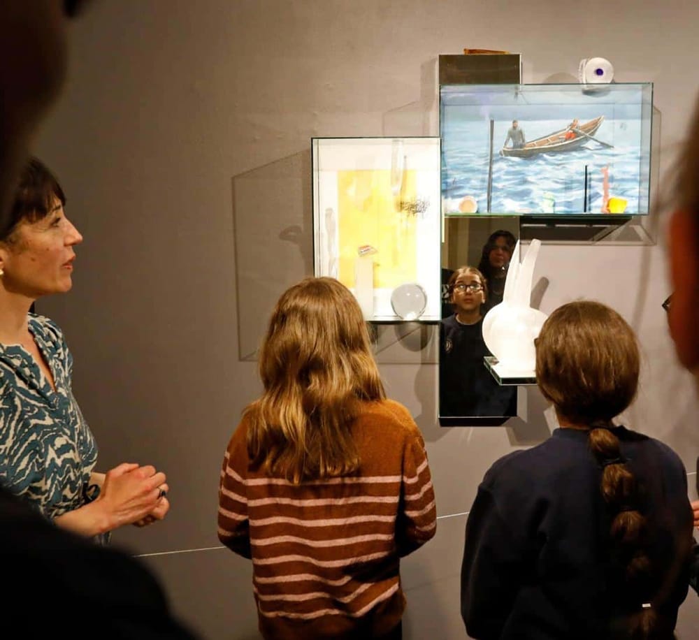 Colorful art exhibit showcasing paintings and sculptures at QuestForDirections gallery.