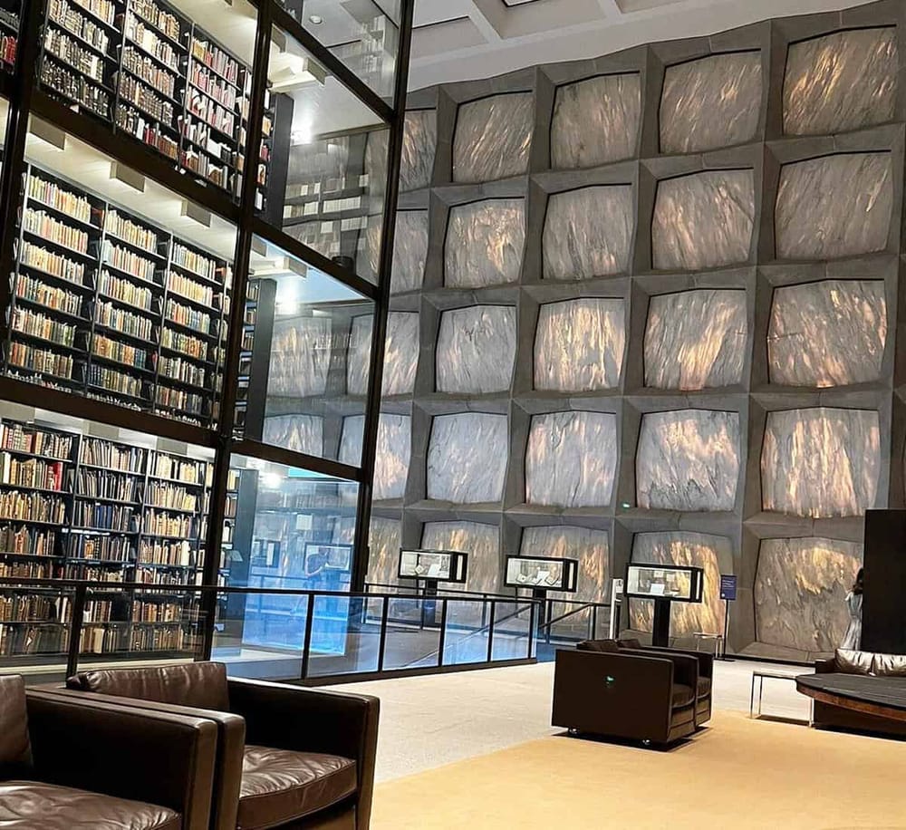 Elegant library interior with towering bookshelves and modern design elements.