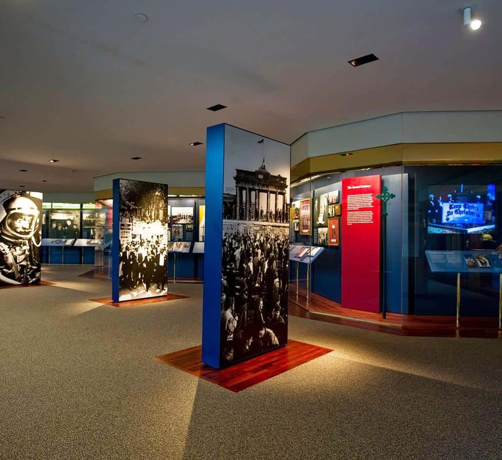 Colorful exhibit gallery showcasing historical photos and memorabilia of notable events.