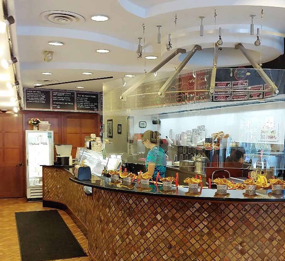 Colorful dessert display at a bakery counter showcasing sweet treats for customers.