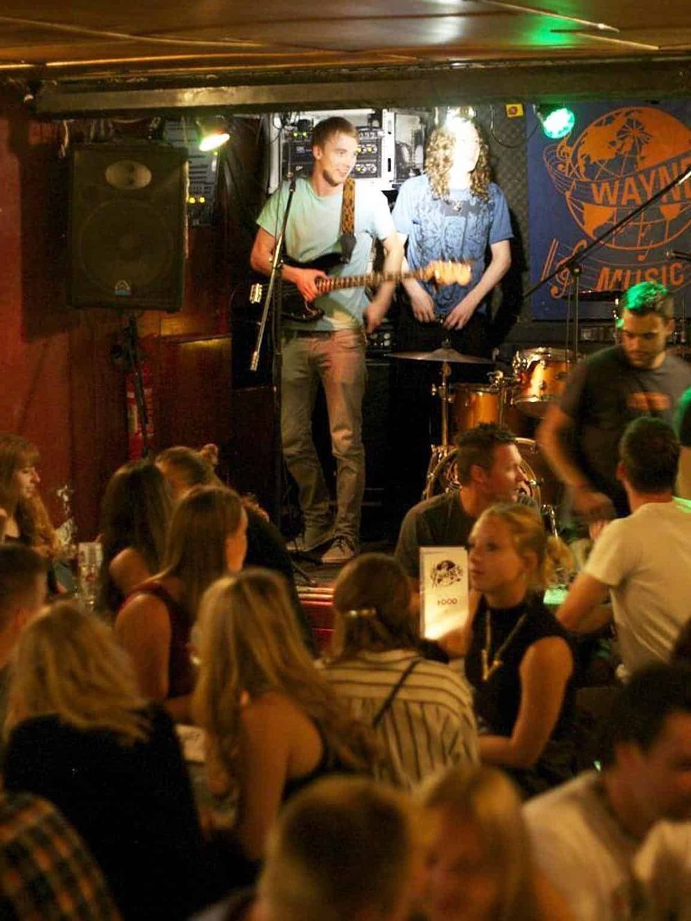 Live music performance at Quest for Directions bar with talented musicians and vibrant nightlife ambiance.