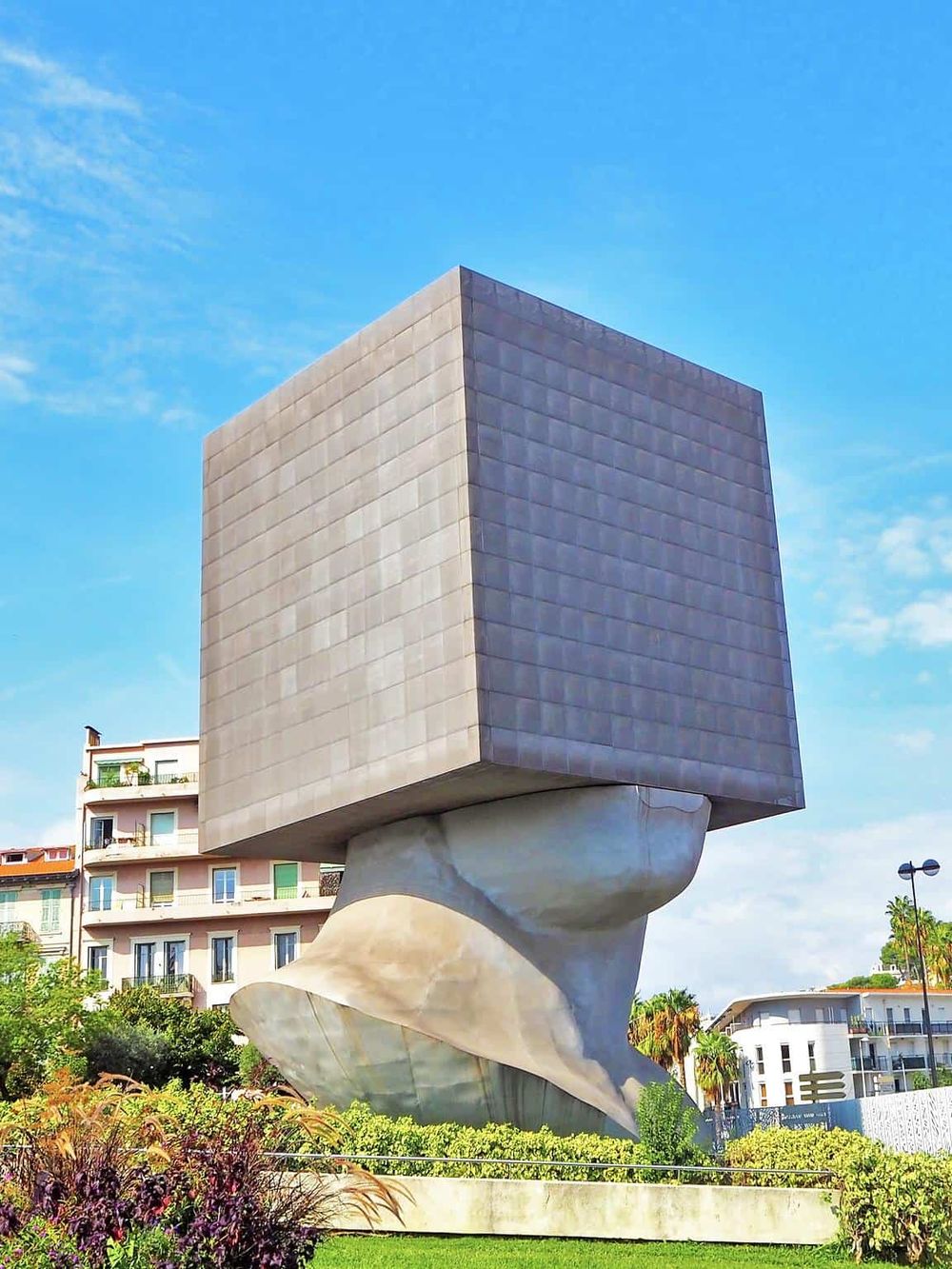 Modern abstract building with unique architectural design in urban park setting.