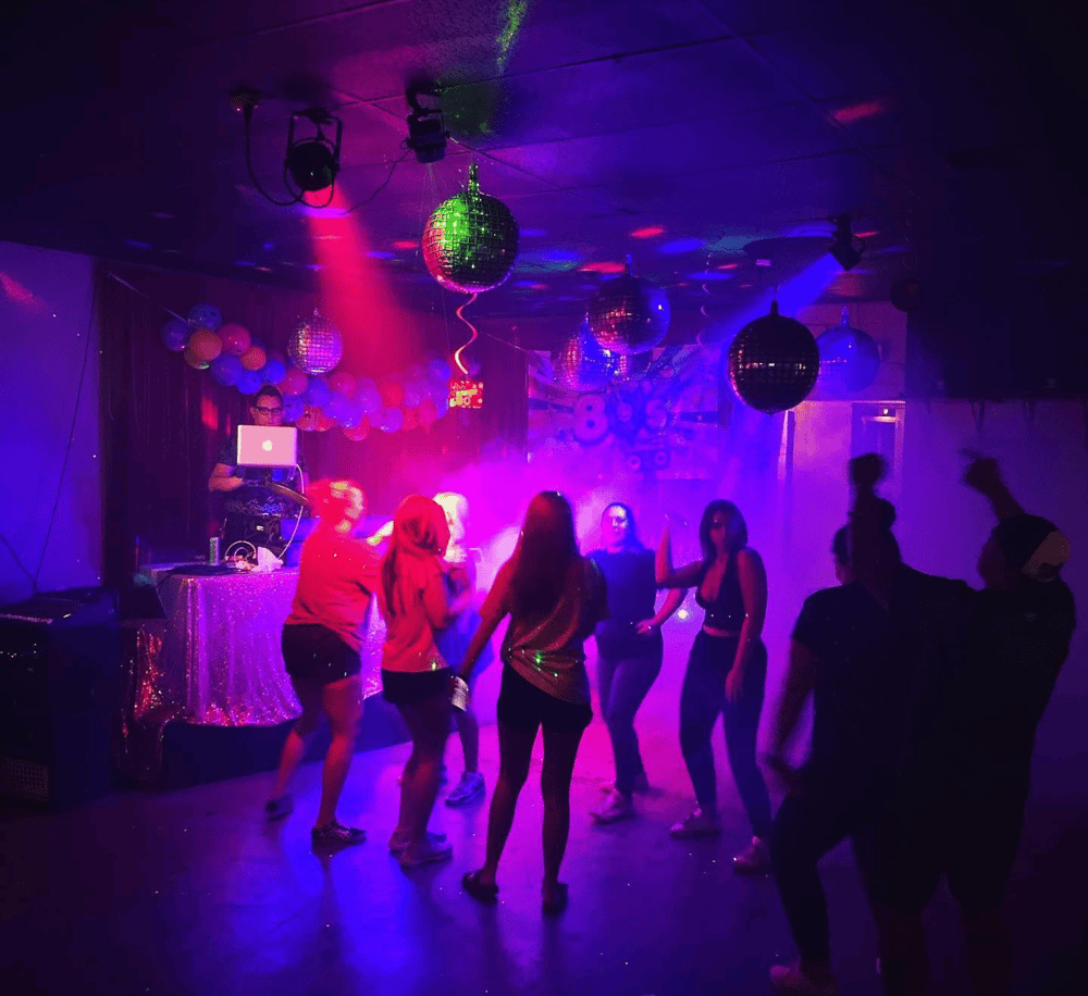 Colorful nightclub dance party with disco balls and vibrant lighting, ideal for nightlife and entertainment venues.