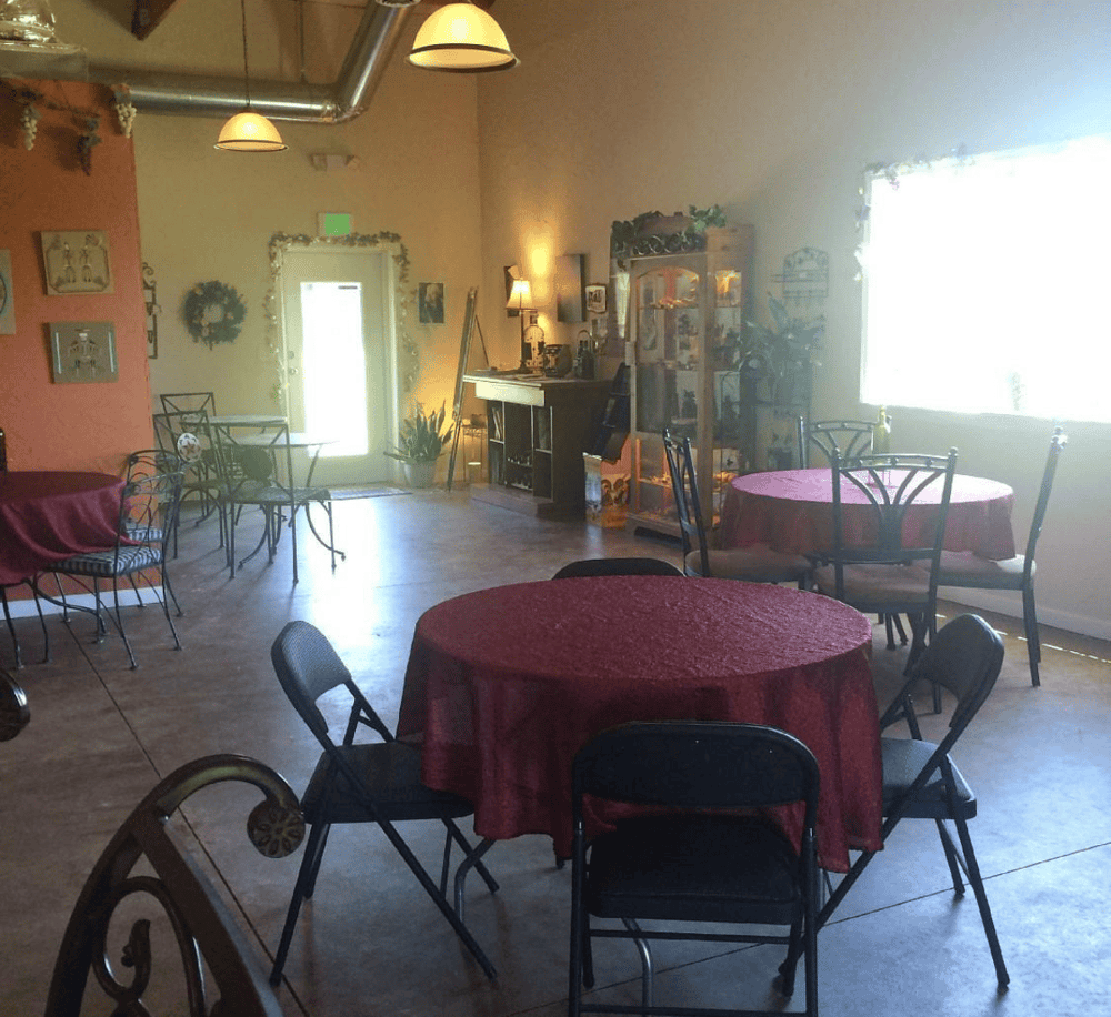 Cozy banquet hall with round tables, elegant decor, and warm lighting, ideal for dining and events.