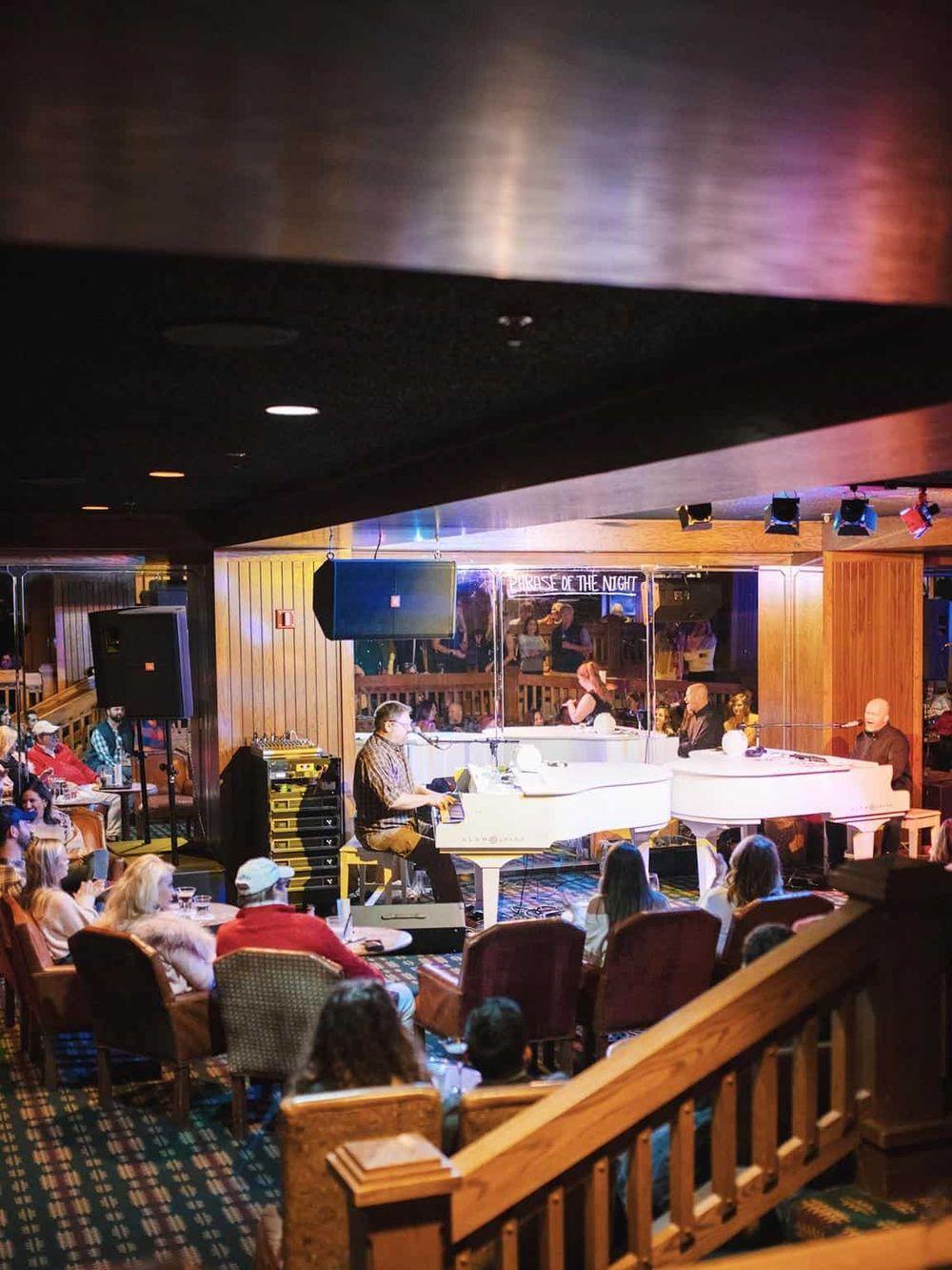 Live jazz piano performance at a cozy, intimate music venue with an engaged audience.