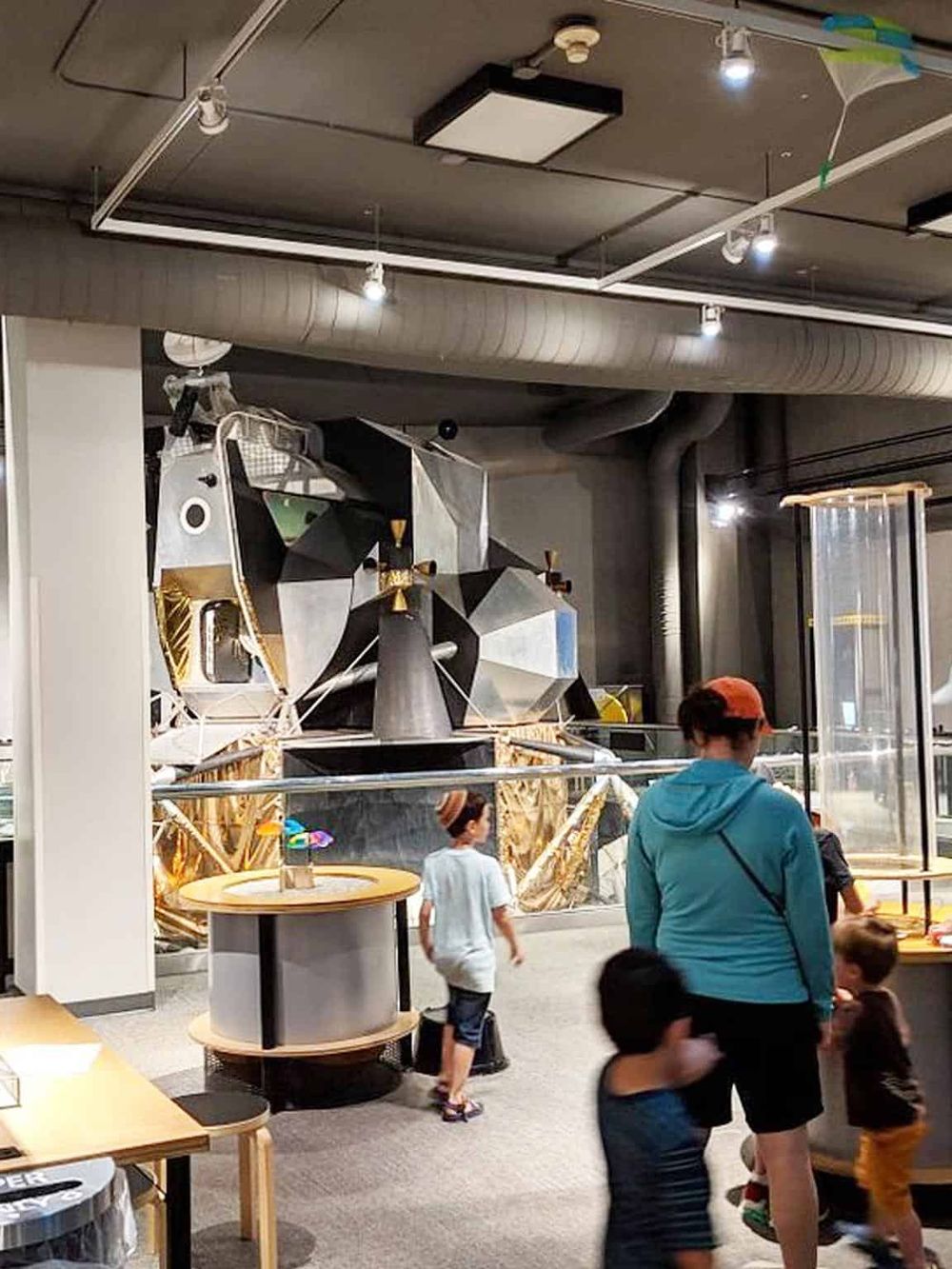 Exploration of spacecraft exhibit at QuestForDirections science center with children and families.