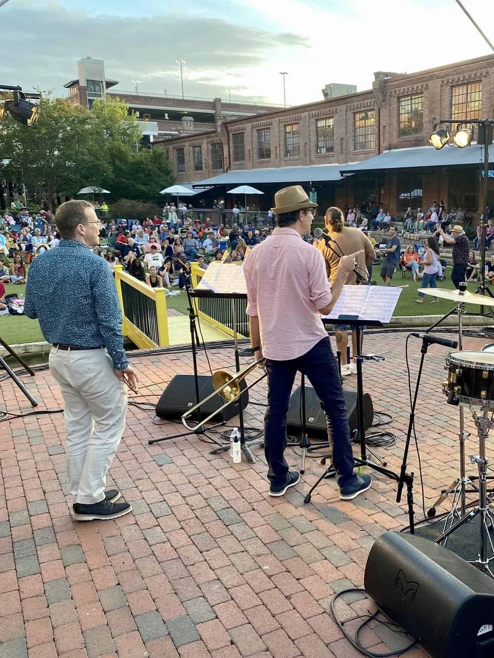 Live outdoor jazz band performing at QuestForDirections event, crowd enjoying music and evening ambiance.