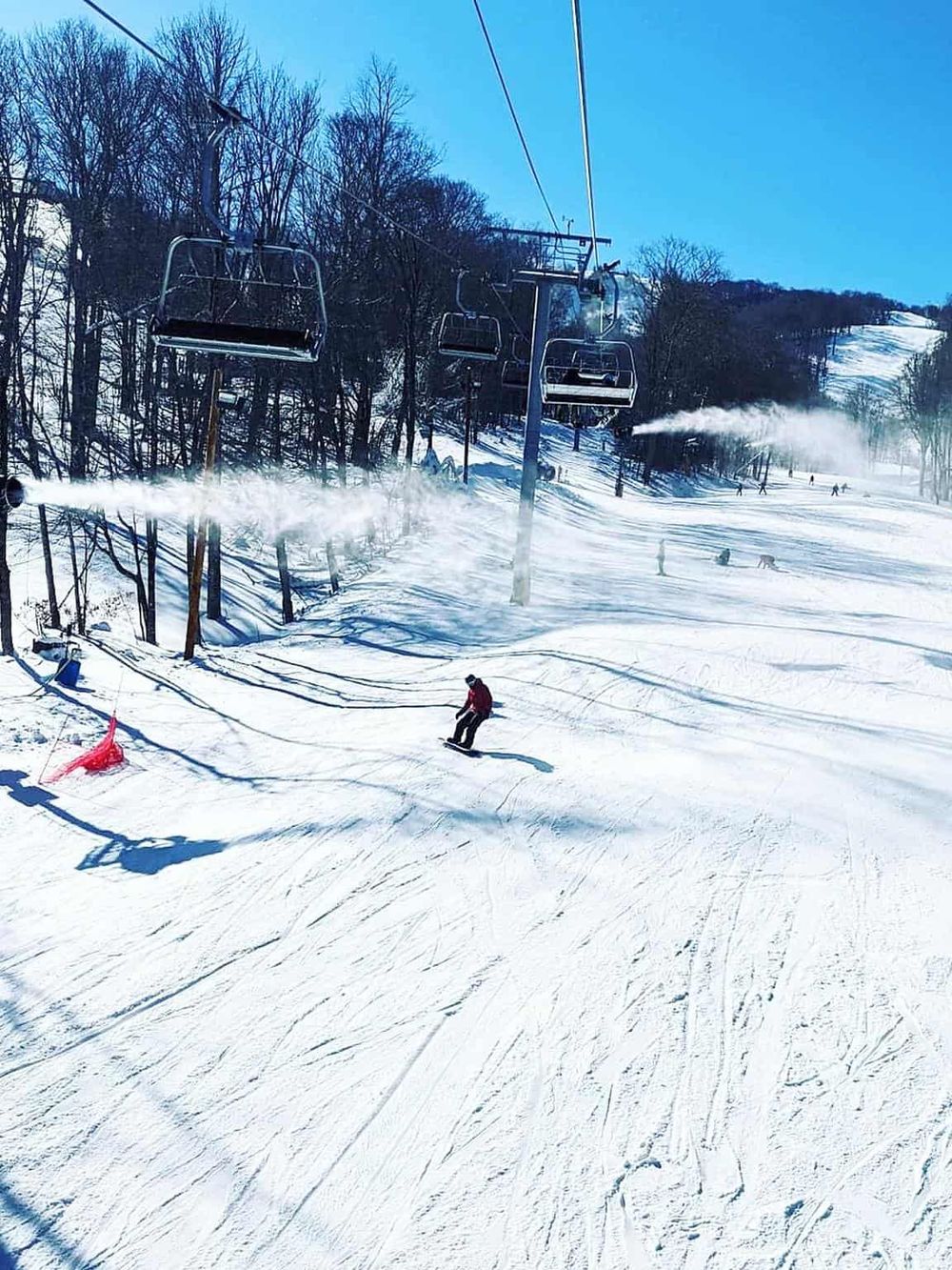 Skiing and snowboarding on a sunny winter day at QuestForDirections ski resort.