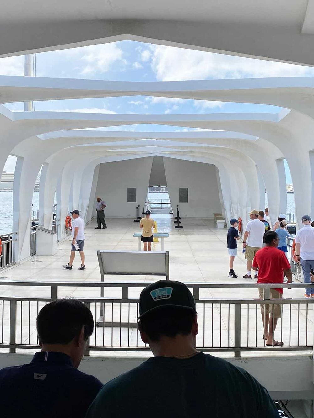 Modern ferry terminal with architectural design and passengers waiting for the boat arrival.