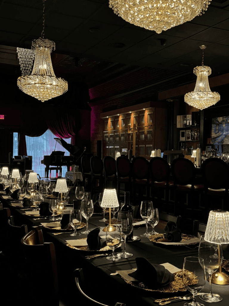 Elegant restaurant with chandeliers, luxurious table settings, and ambient lighting for fine dining.