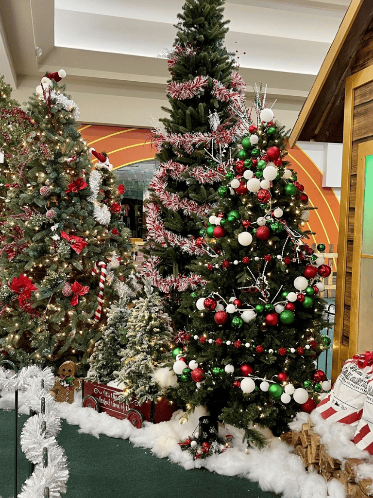 Christmas decorated trees with ornaments and lights at QuestForDirections holiday display.