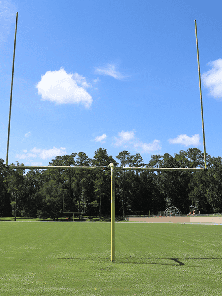 1. Goalpost on a sports field under a clear blue sky.