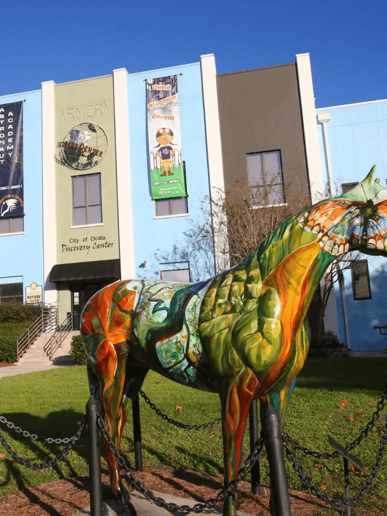 Brightly painted horse sculpture outside City of Ocala Discovery Center in Florida.