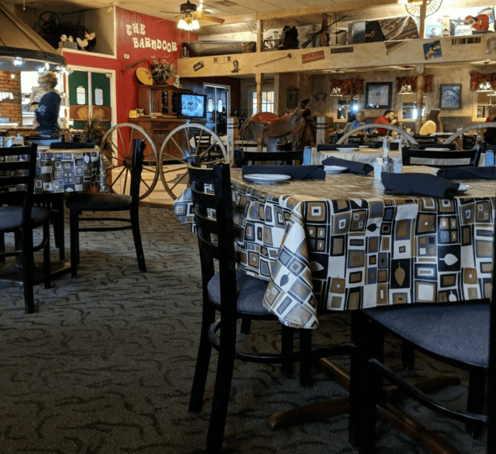 Rustic western-themed restaurant interior showcasing vintage decor and cozy atmosphere.