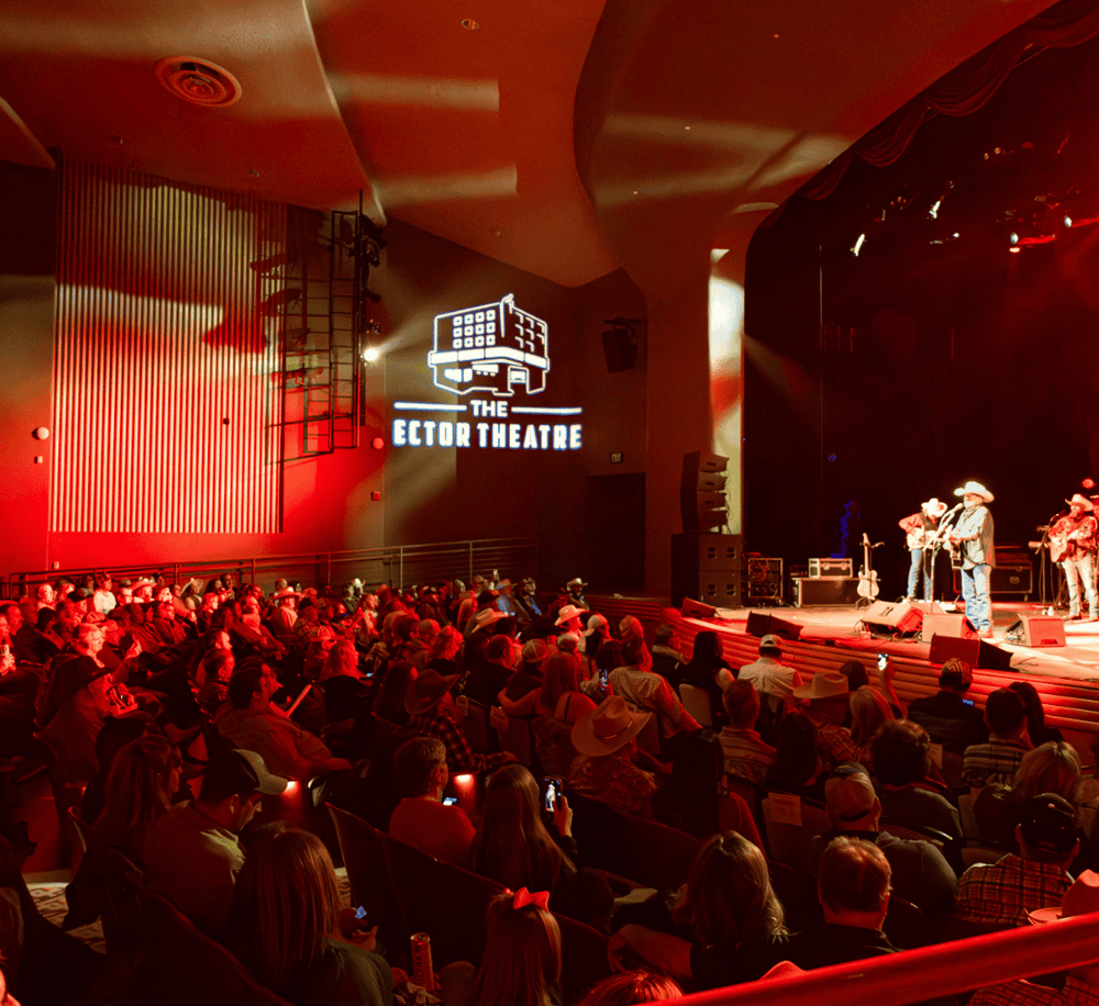 Bright stage at The Ector Theatre with live country music performance and audience enjoying the concert.
