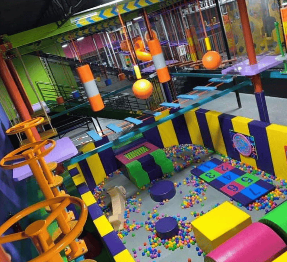 Colorful indoor playground with ball pit, slides, and interactive play zones for kids.
