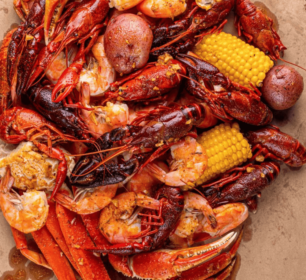 Succulent seafood boil with crawfish, shrimp, potatoes, corn, and crab, perfect for seafood lovers.