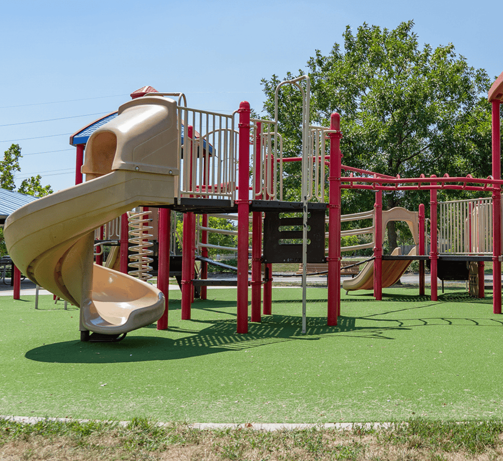Colorful playground slide and climbing structure for kids at outdoor park, ideal for children’s recreation and fun.