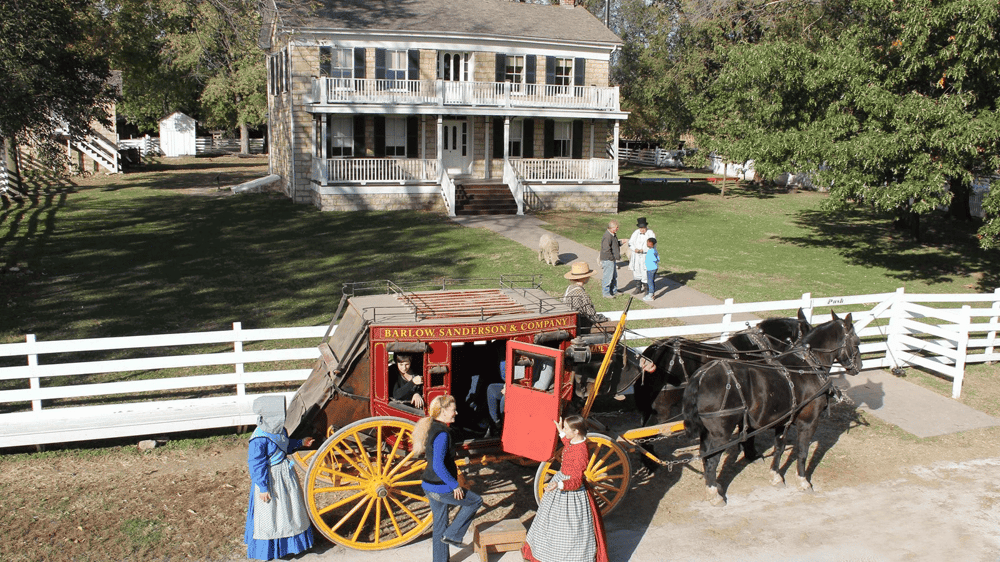 Horse-drawn wagon ride at historic site, family fun activity, scenic outdoor attraction.