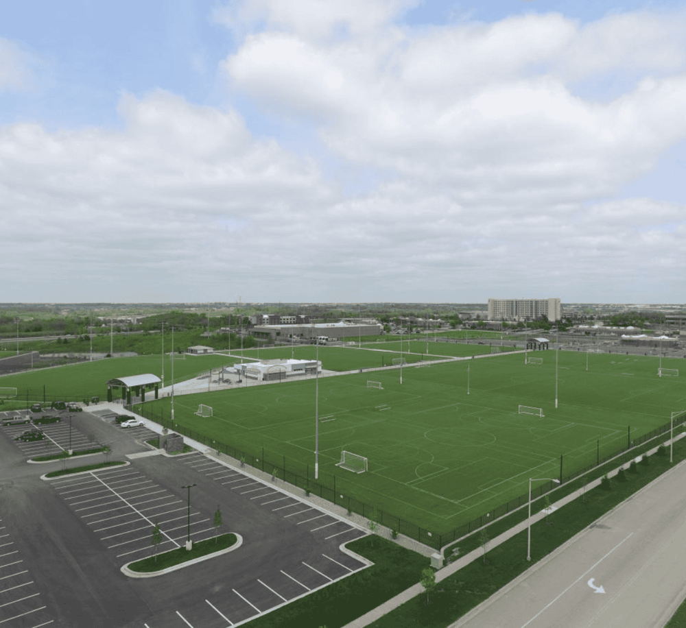 Aerial view of soccer fields and parking lot at QuestForDirections sports complex in Texas.