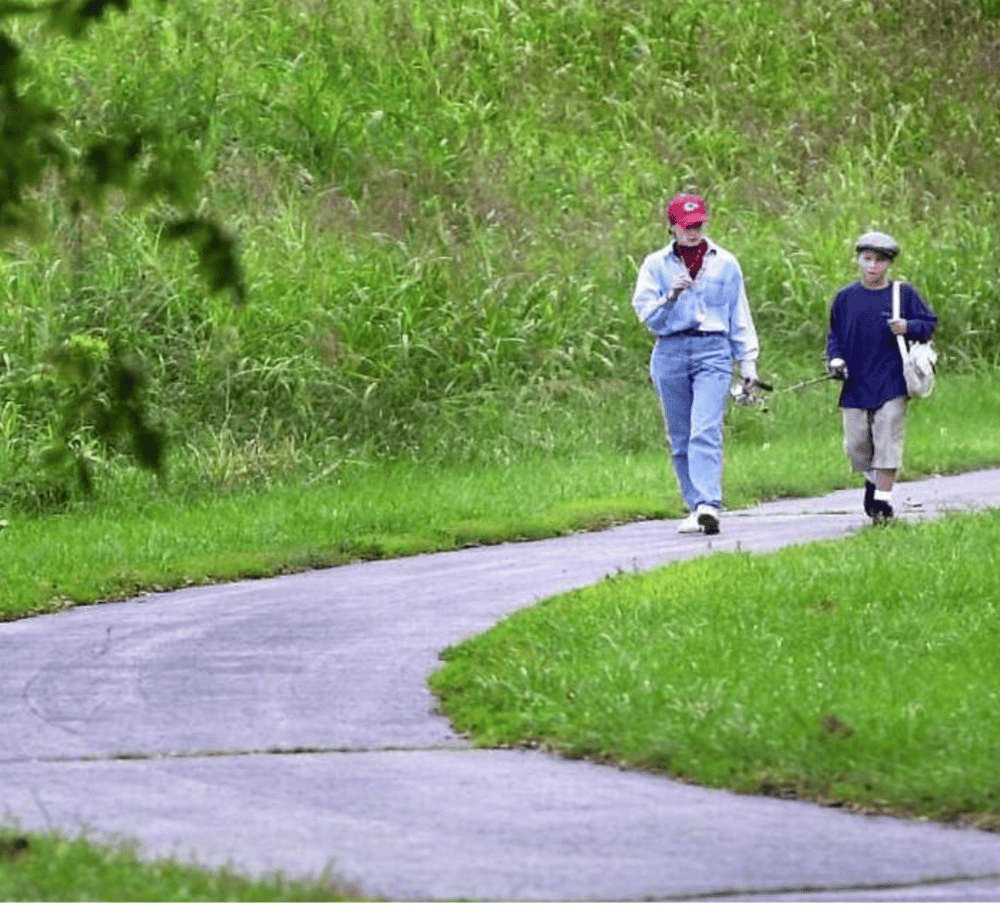 Child and adult walking on a nature trail, outdoor adventure, family exploration, scenic park, Quest For Directions.