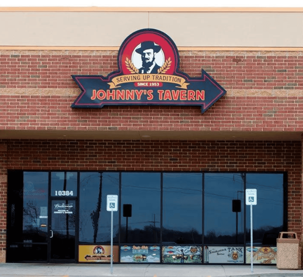 Historic Johnny's Tavern restaurant sign on brick building, serving up tradition since 1953.