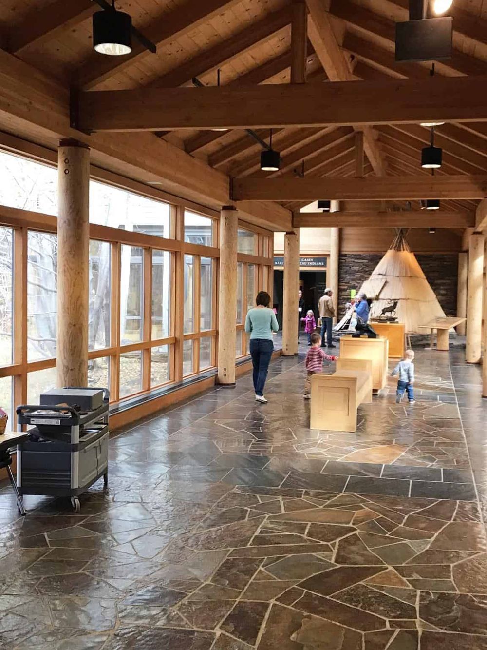 Bright, spacious indoor lobby with wooden architecture and natural light, inviting visitors to QuestForDirections.