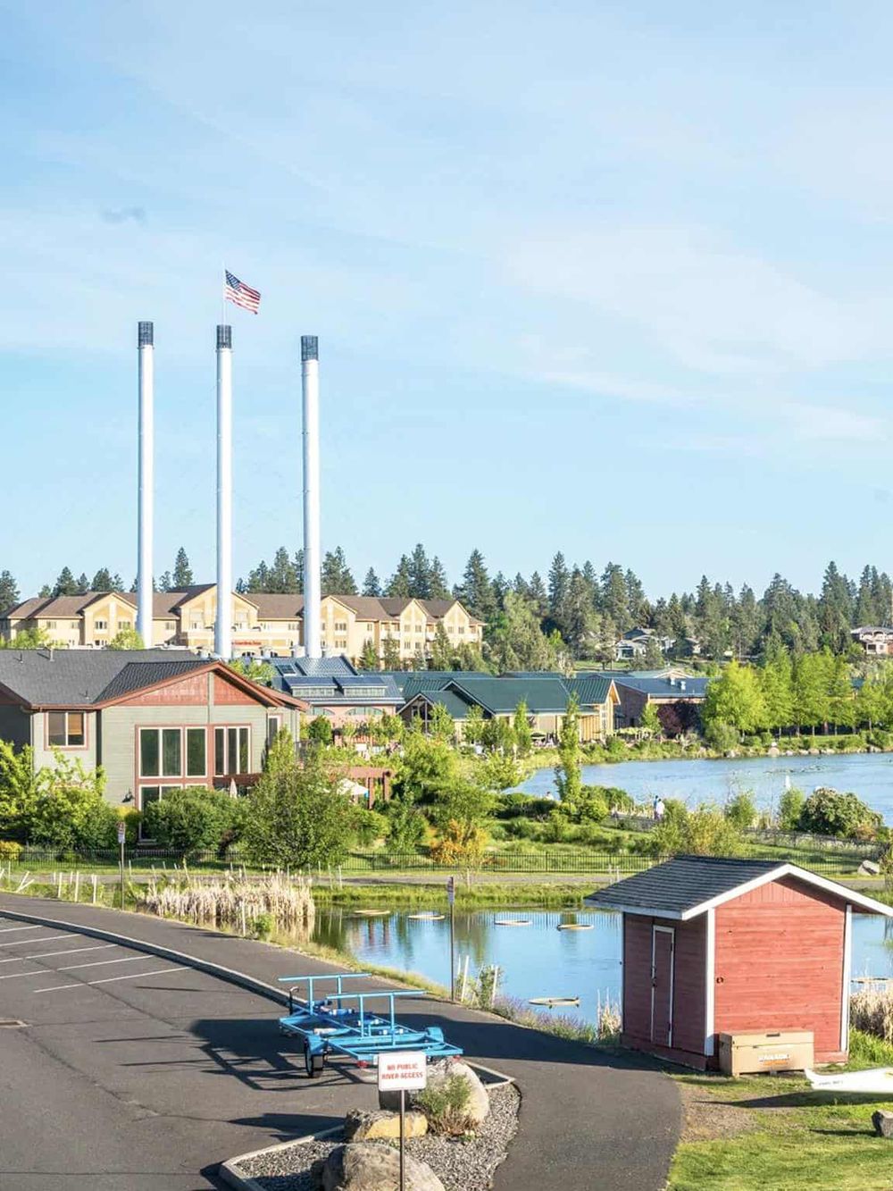 Scenic lakeside neighborhood with townhomes, water views, and American flags near QuestForDirections.