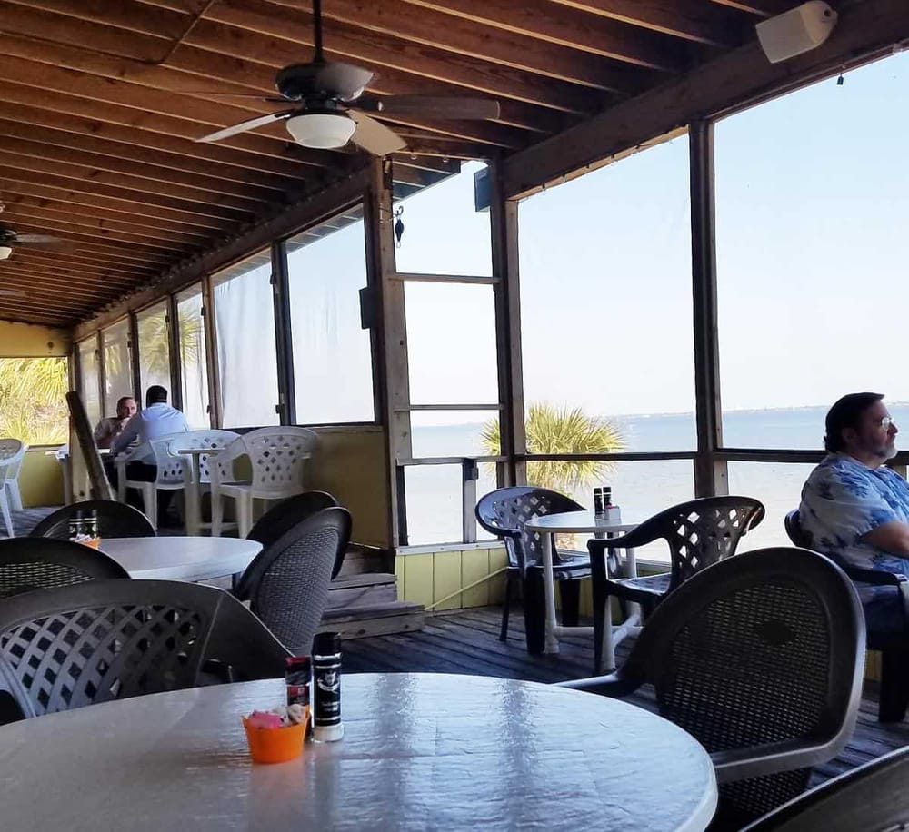 Relaxing beachfront restaurant patio with ocean views and ocean breeze.