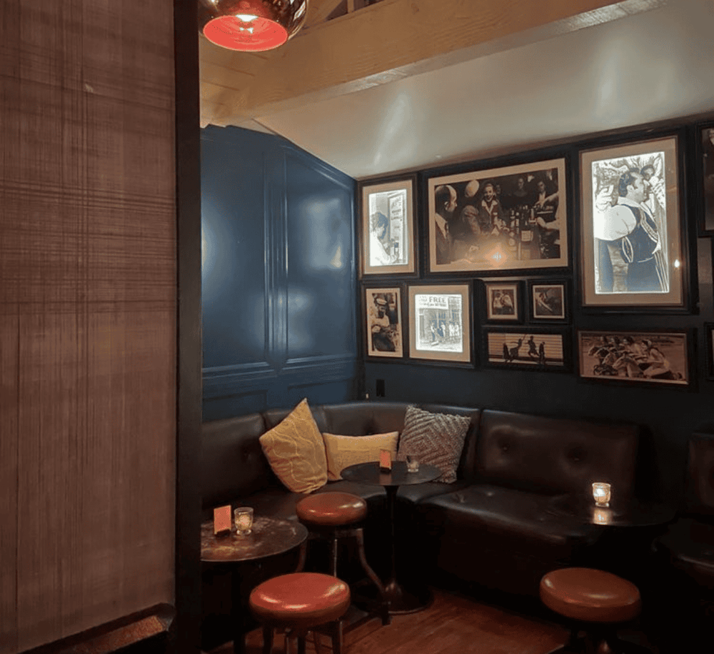 Cozy lounge with wall art and mood lighting at Quest For Directions restaurant.